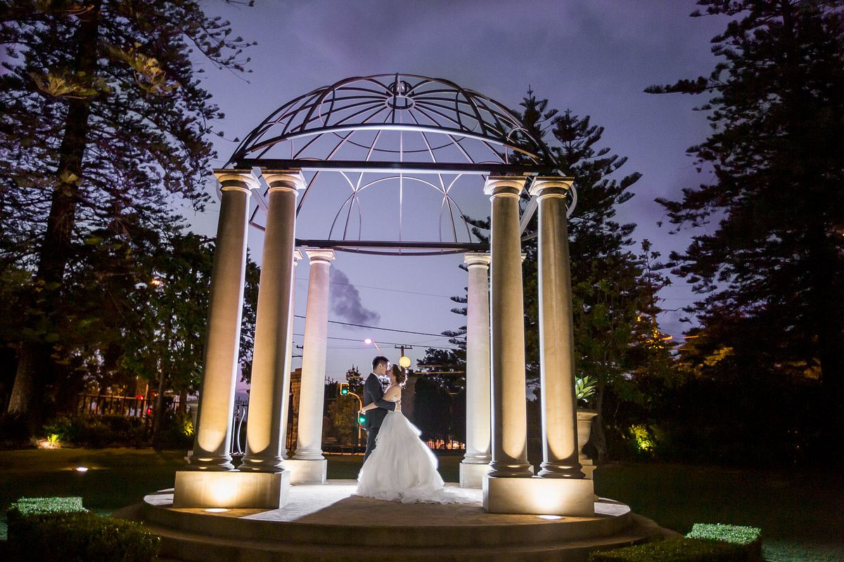 Romantic bridal portraits of a bride and groom sharing a kiss at the Garden Chateau at Curzon Hall.
