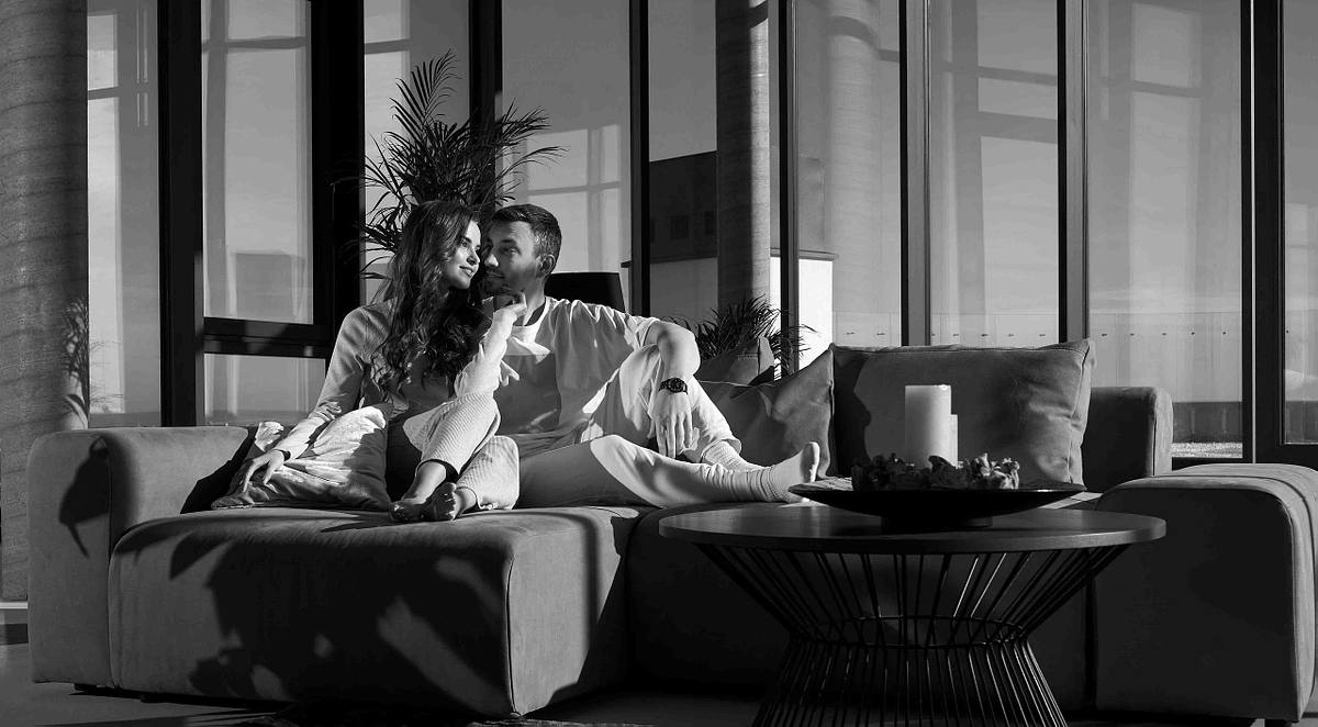Happy couple resting at home with good mood.