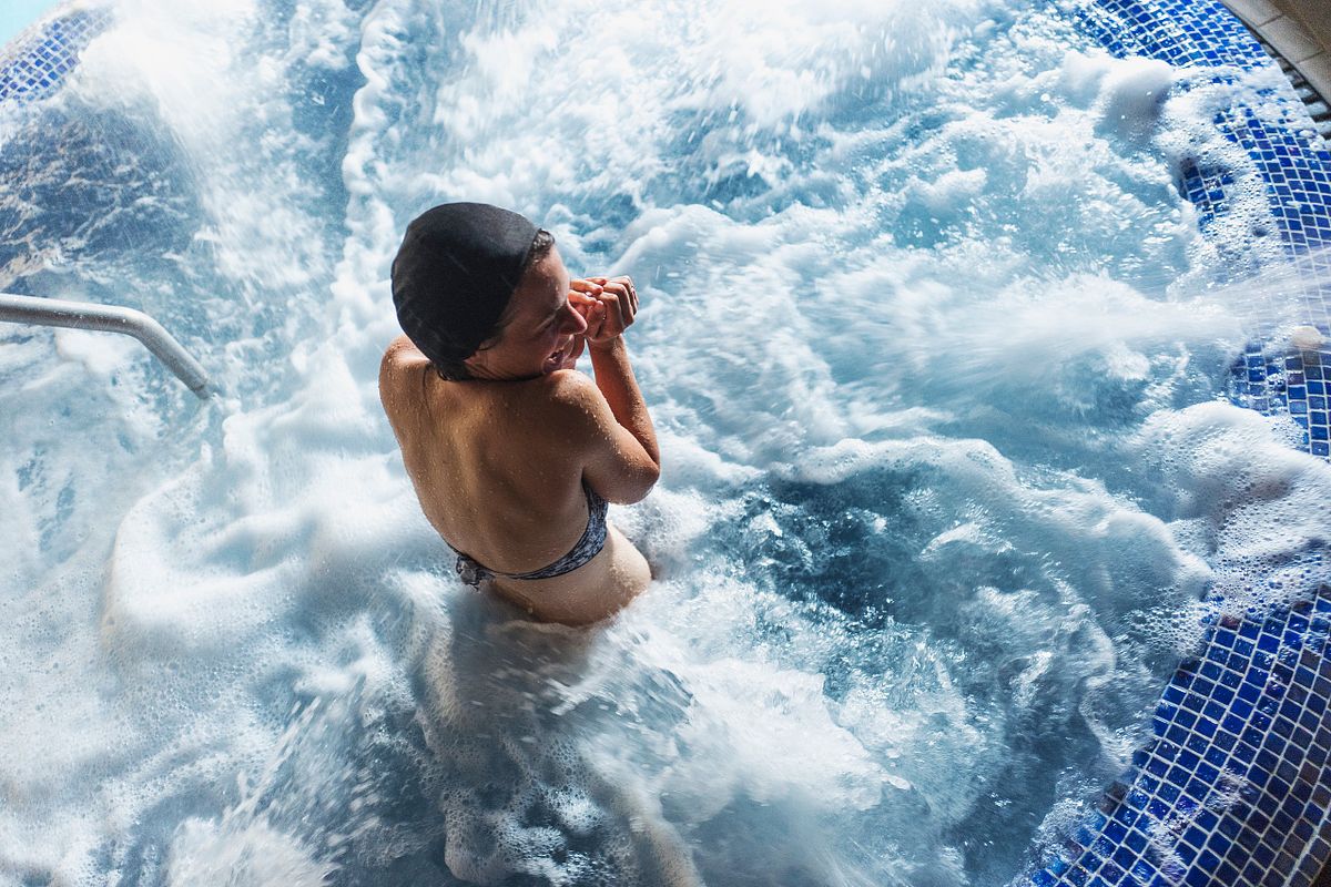 Guest relaxing in a spa pool, lifestyle imagery for hospitality branding