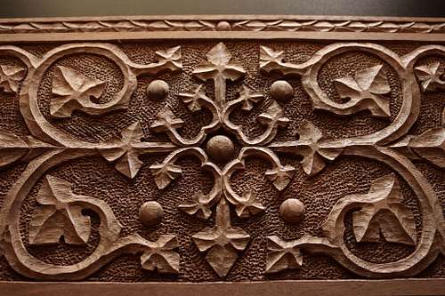 closer detail of the face carving inspired by Gothic Revival architect A.W.N. Pugin