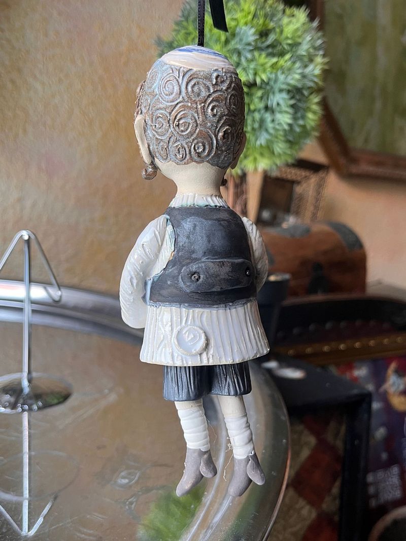 Traditional boy with a fish, little ceramic hanging sculpture