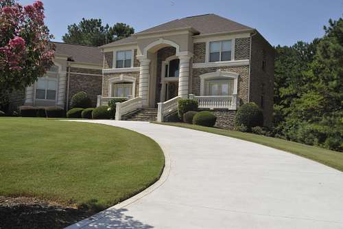 Stately two-story brick home with a charming driveway