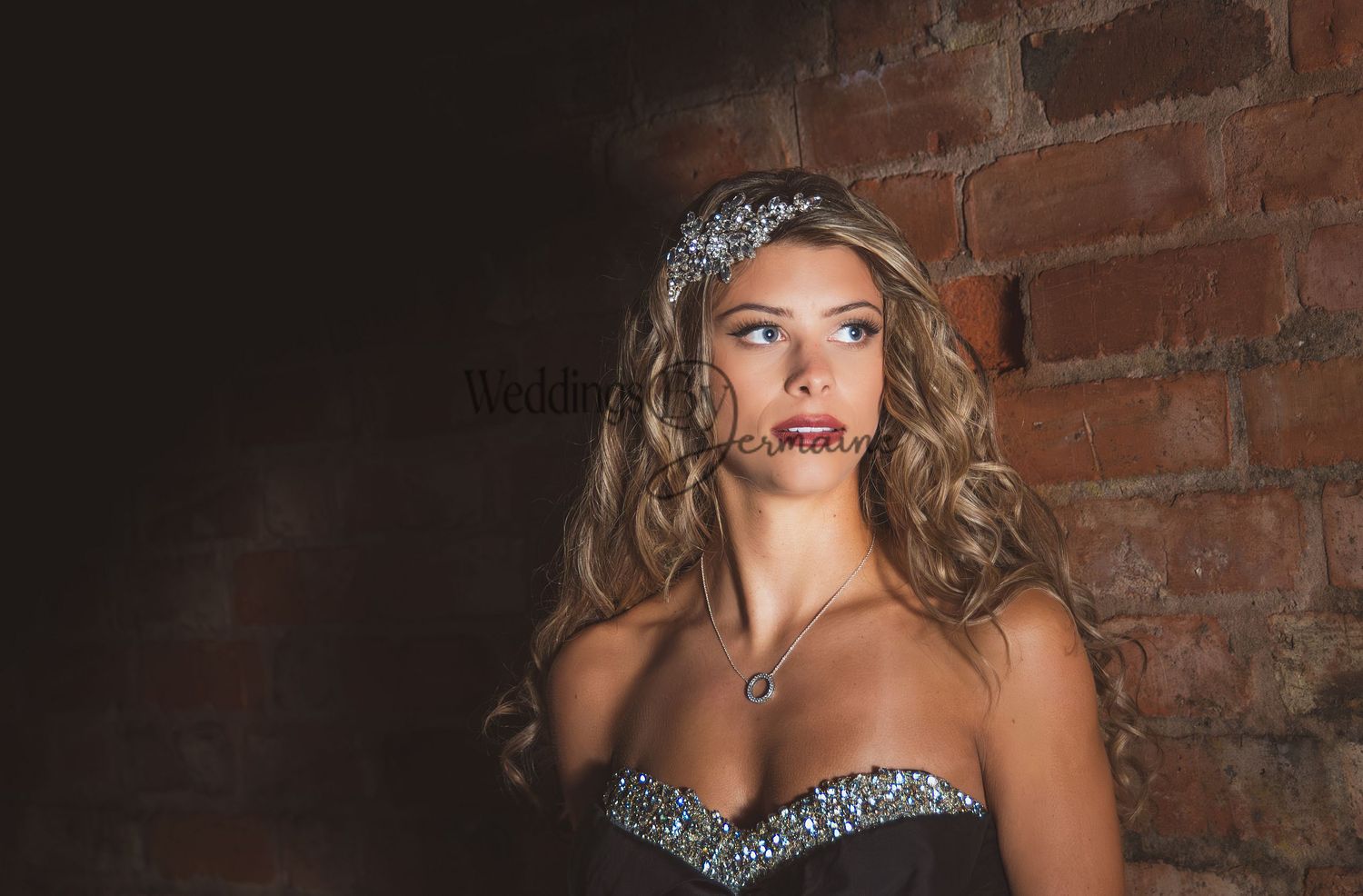 Close-up of a model in a black wedding dress from Bridal Re-Loved Leicester, looking sideways, photographed by Weddings by Jermaine, with hair and makeup by Justaboutweddingshair and beauty, and accessories by Sydney Grace Bridal