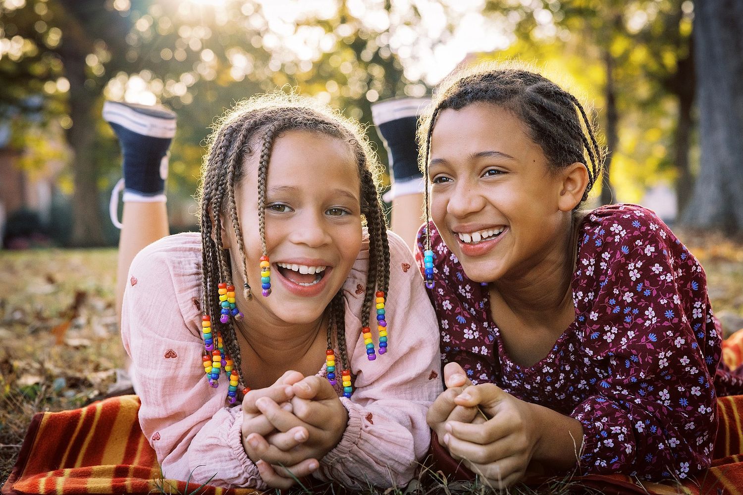 Two young girls on a blanket at Golden Hour on UNC's Chapel Hill campus.