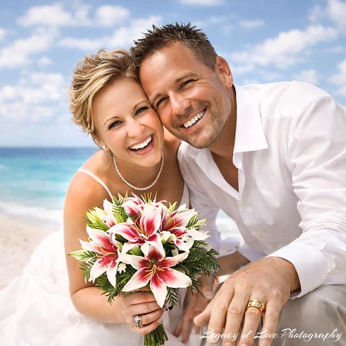 A happy bride and groom on a sunny Northeast Florida beach, photographed by Legacy of Love Photography.